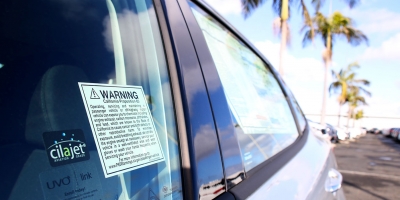 Proposition 65 warning sticker on the window of a new car