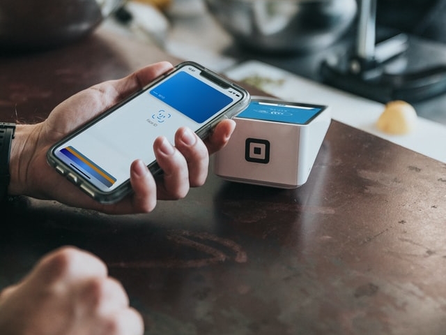 Man using his iPhone to pay