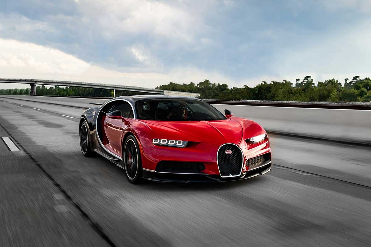a red Bugatti, speeding down the highway