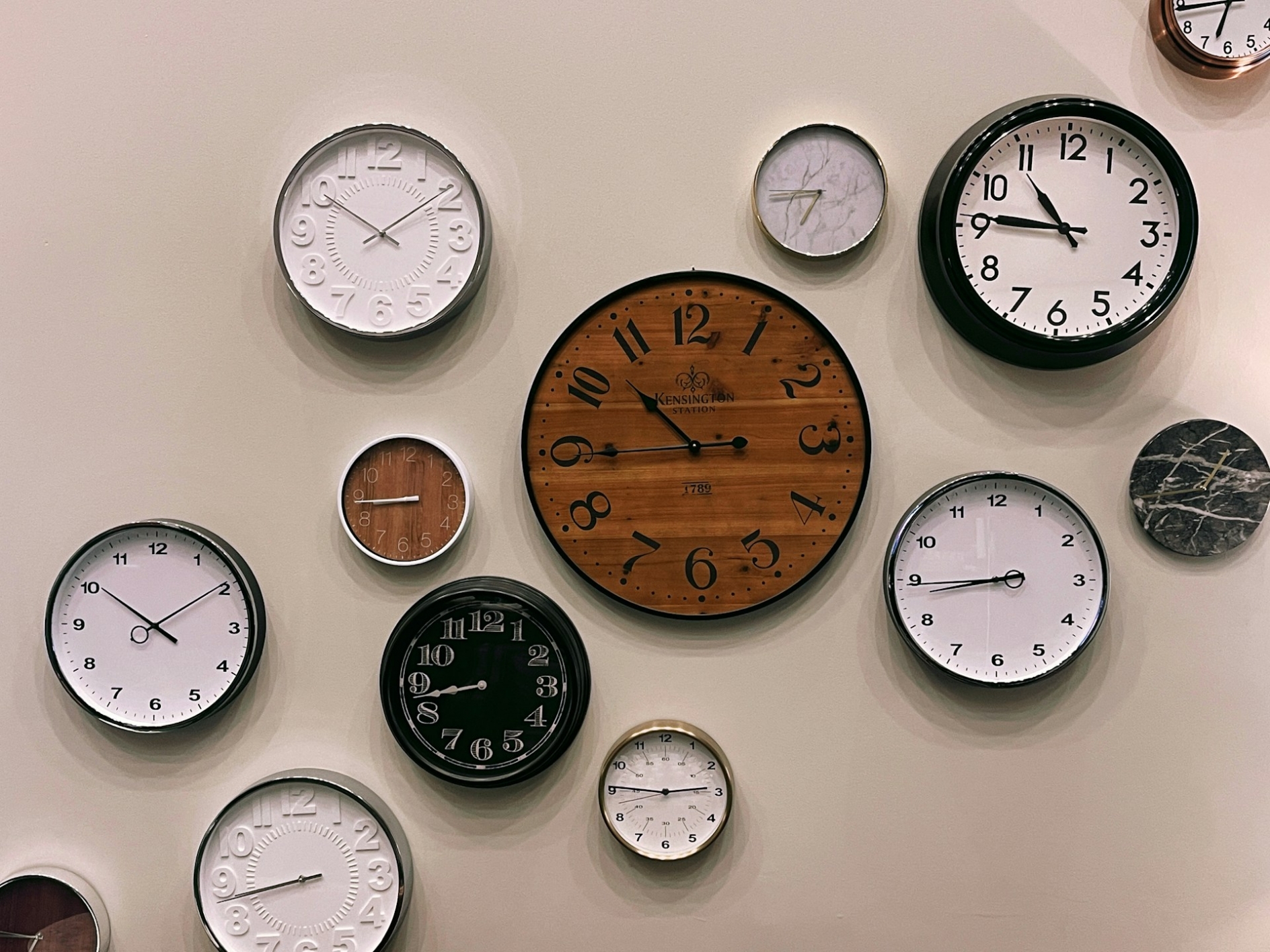 An assortment of round wall clocks.