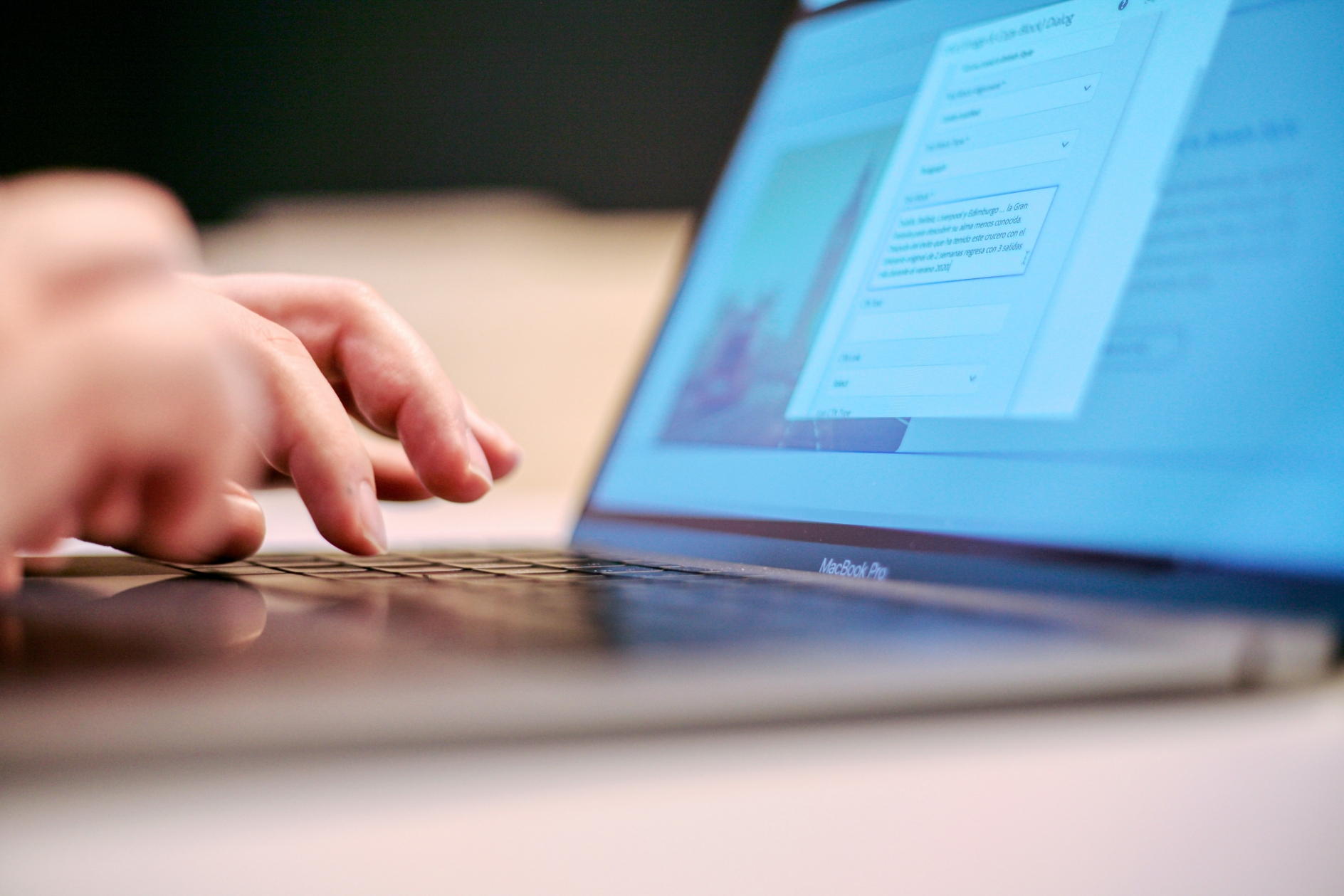 Hands typing on a notebook computer