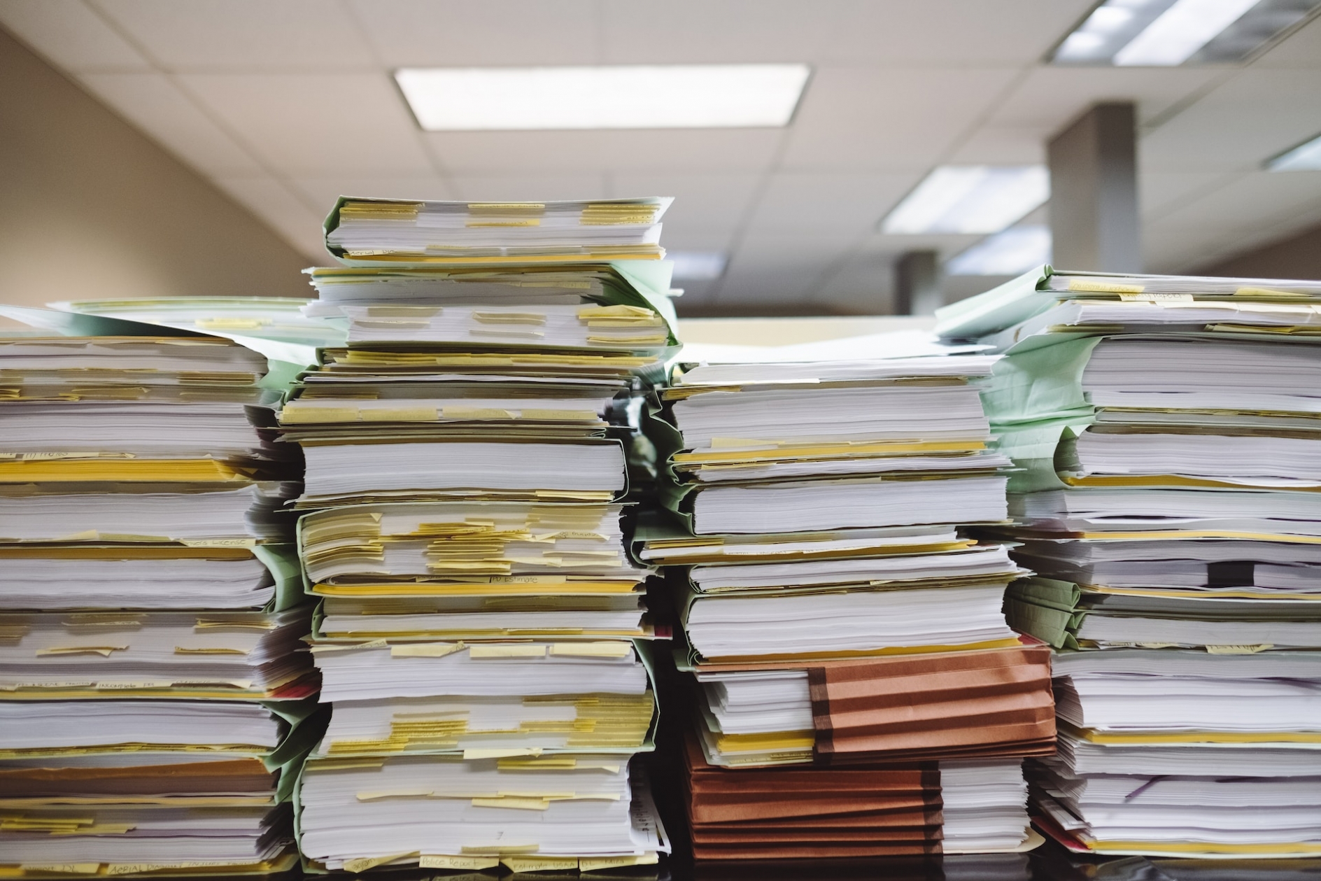 Four large piles of documents