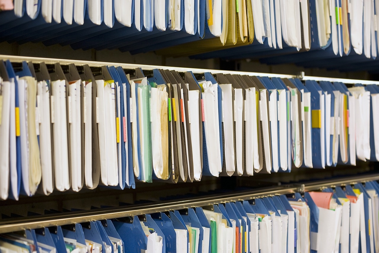 A wall of hanging files, full of papers