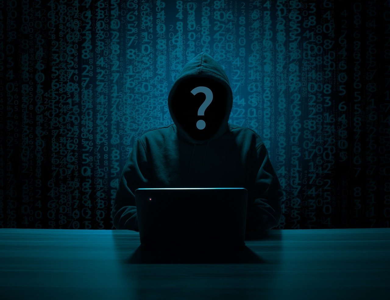 A person sitting at a computer in a dark room, wearing a black hoodie, with a question mark over their hooded face and numbers pouring down in the background