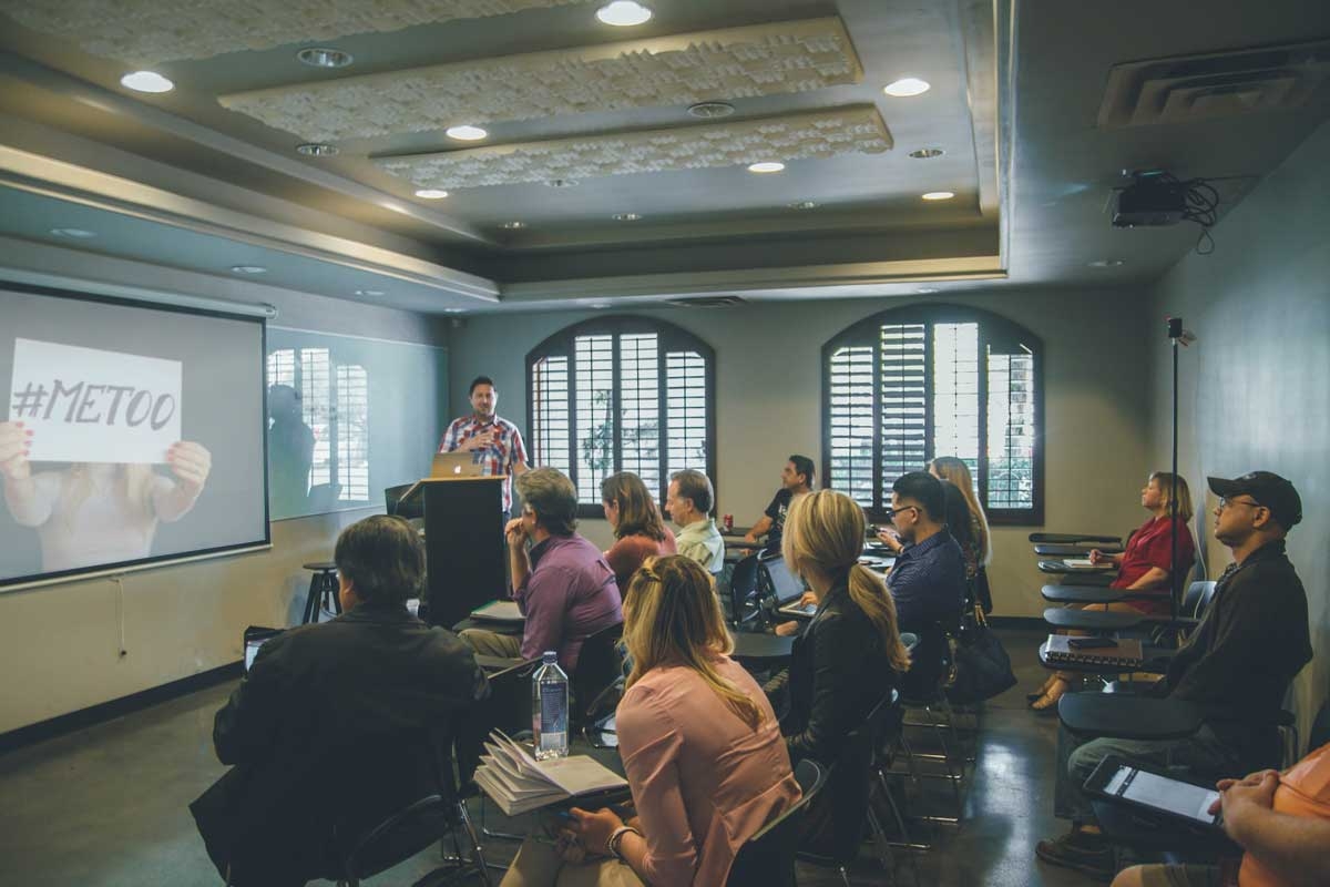 A classroom full of adults, watching a presentation
