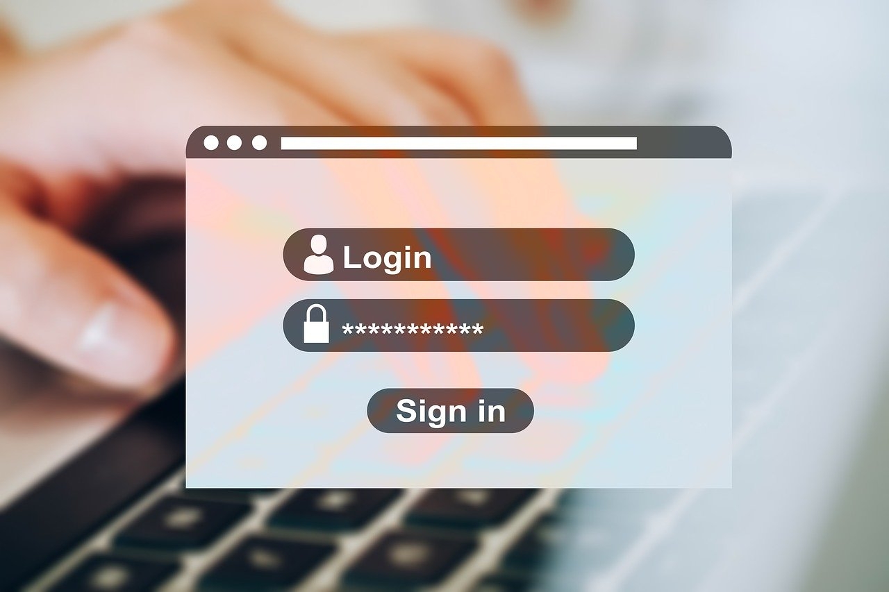 A login form superimposed on a photo of hands on a notebook computer keyboard