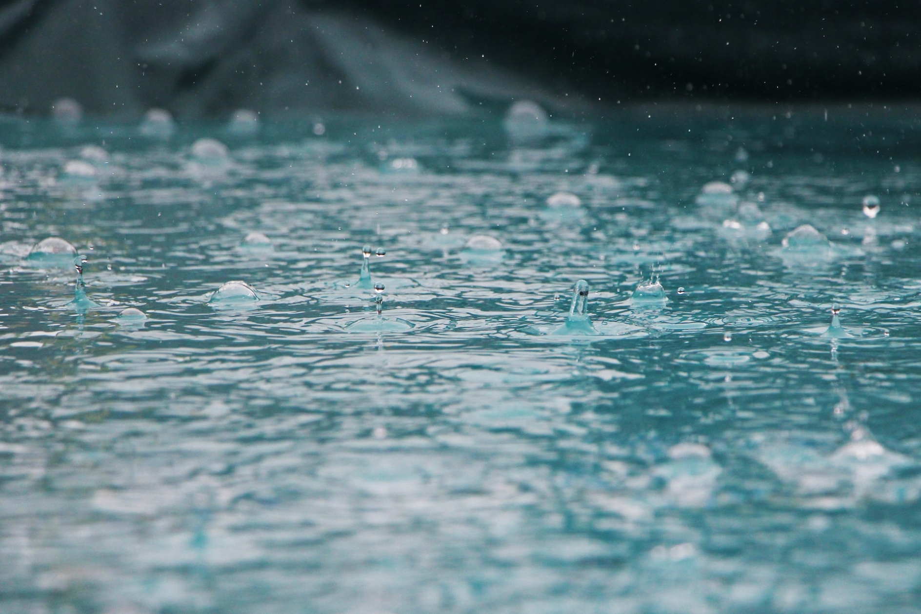 Photo of rain hitting the surface of water