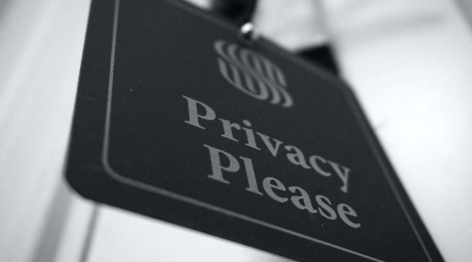 Closeup photo of a hotel door placard that reads Privacy Please