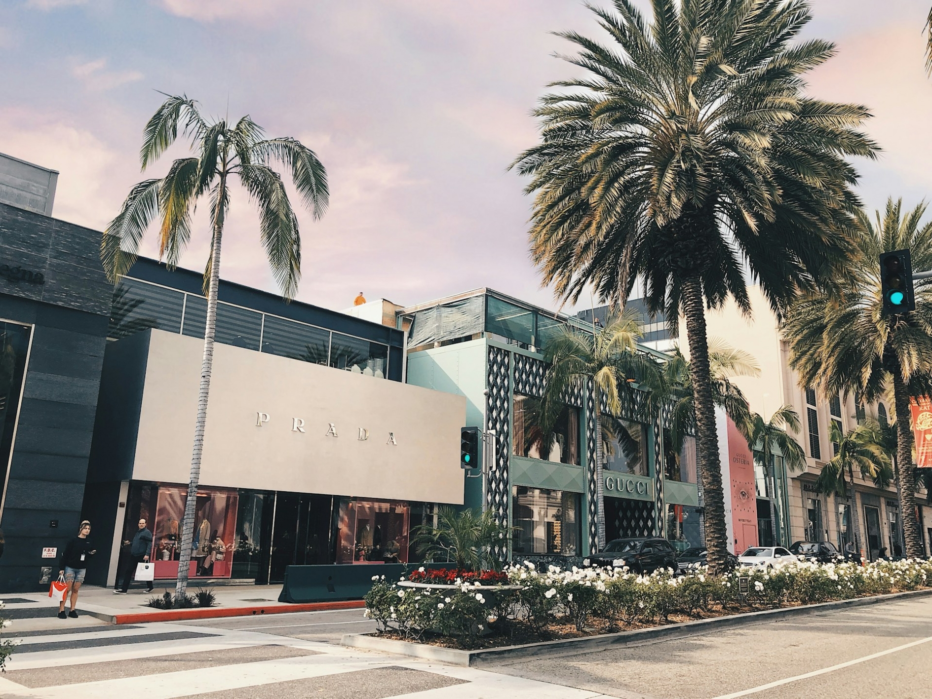 Photo of a luxury shopping district, on a palm tree lined street