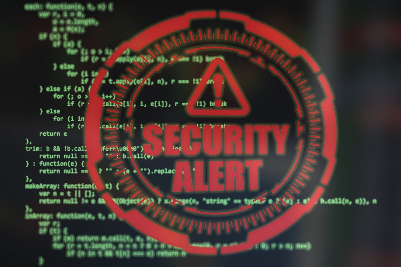 A Security Alert warning overlayed on a screen of computer code