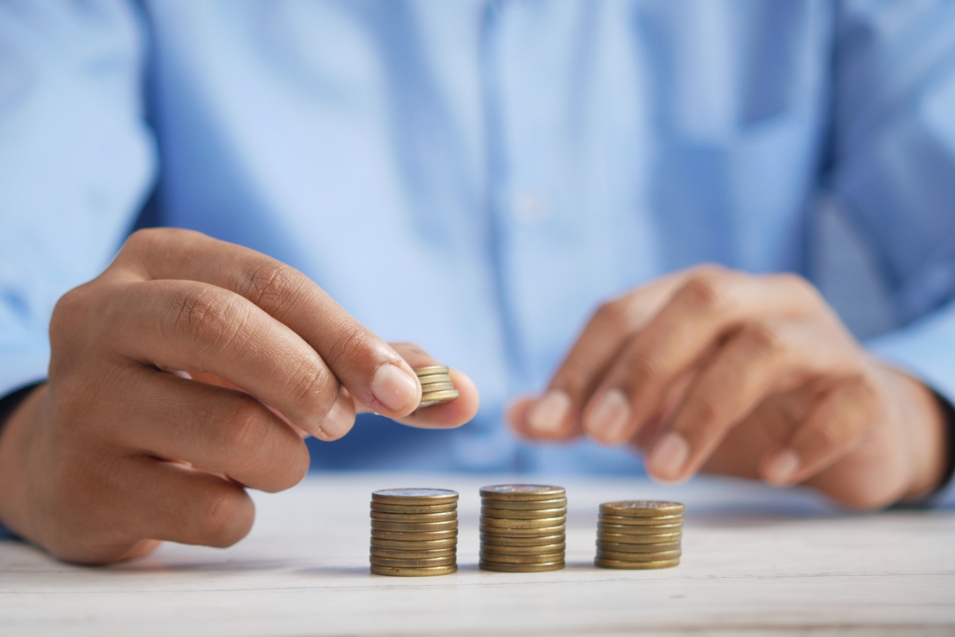Closeup of someone's hands stacking coins