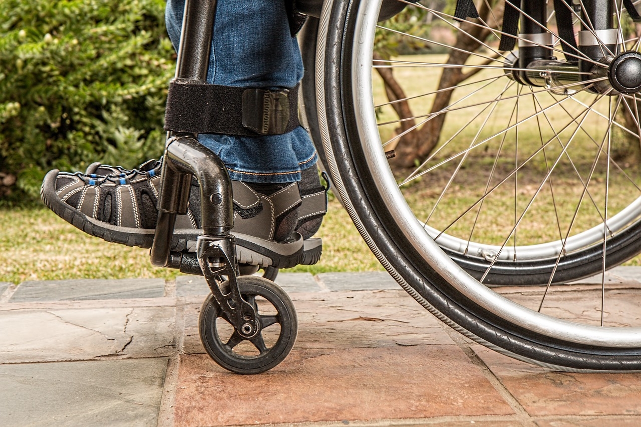 Photo of a person's feet, from the side. while riding in a wheelchair